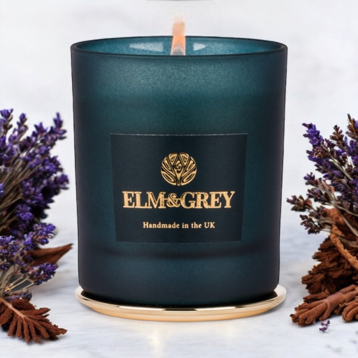Limited edition blue candle container surrounded by lavender myrrh tonka and sitting on a gold lid