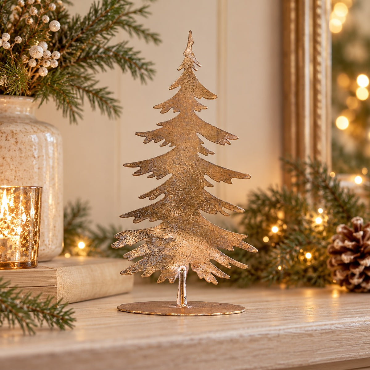 Gilded fir tree styled with reindeer, greenery and candlelight