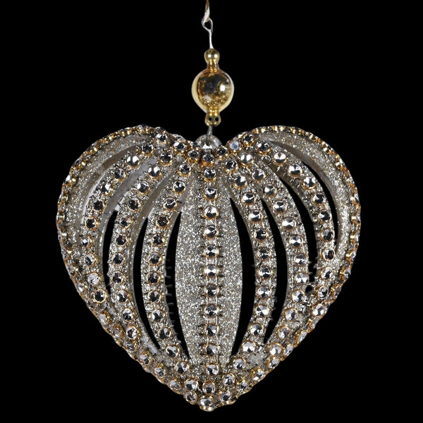 Decorative heart-shaped ornament with rhinestones on a black background