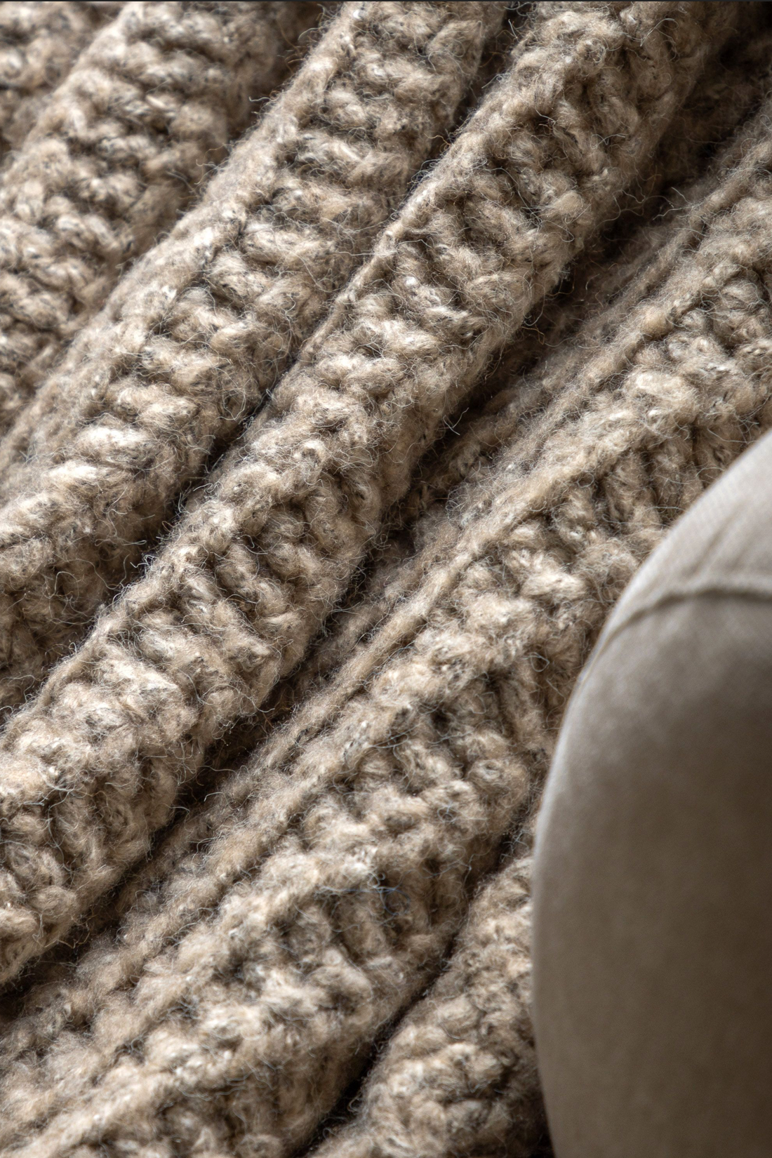 Close-up of a textured beige blanket on a surface