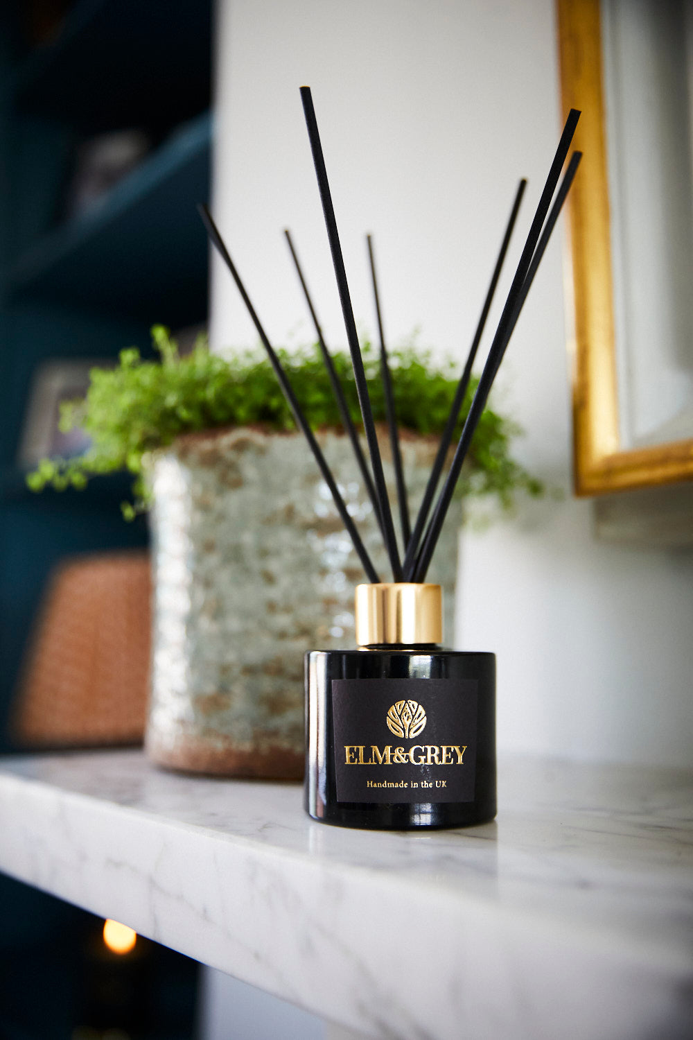 Elm & Grey diffuser on a countertop with a blurred background