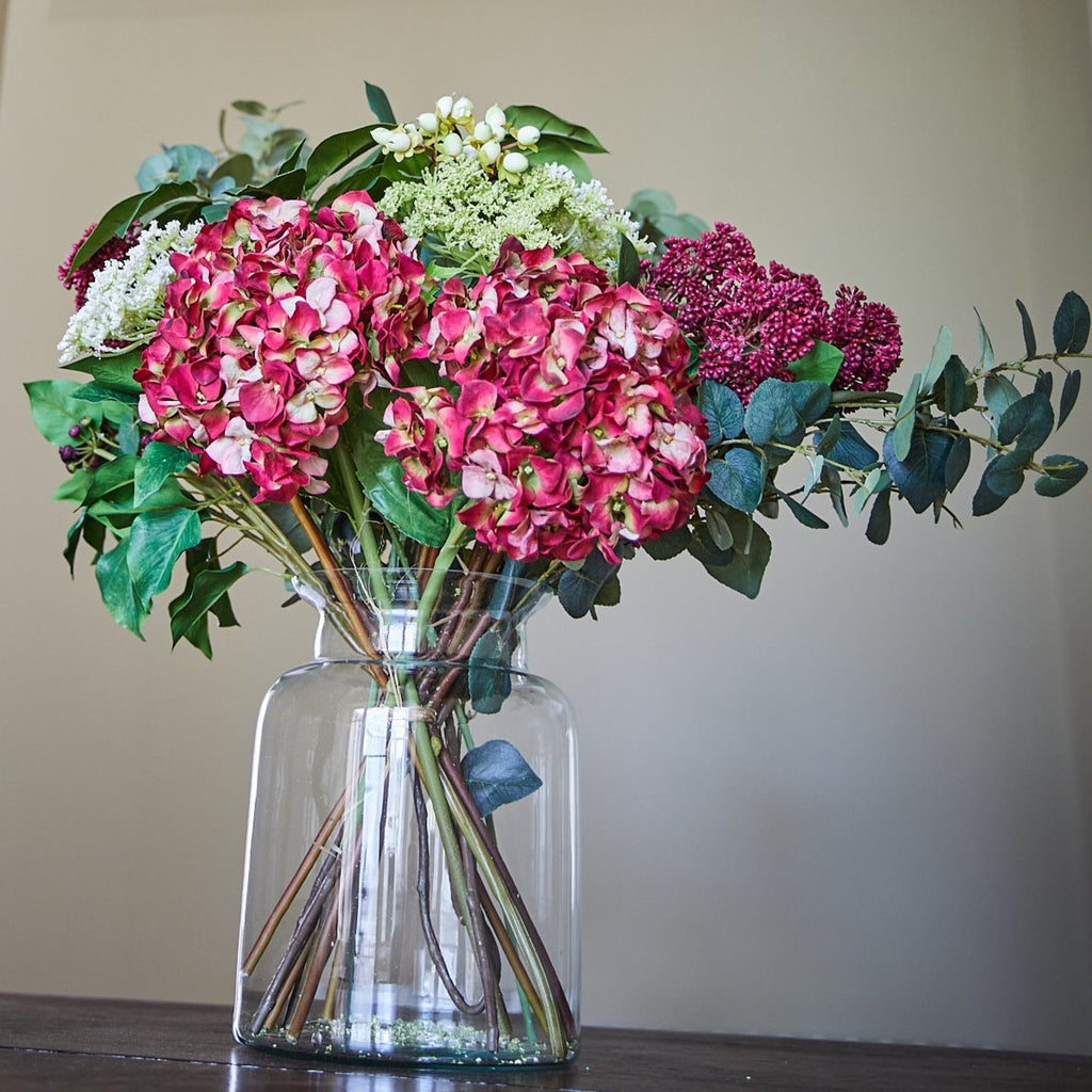 Hand tied seasonal bouquet on a table eucalyptus hydrangea Burgundy