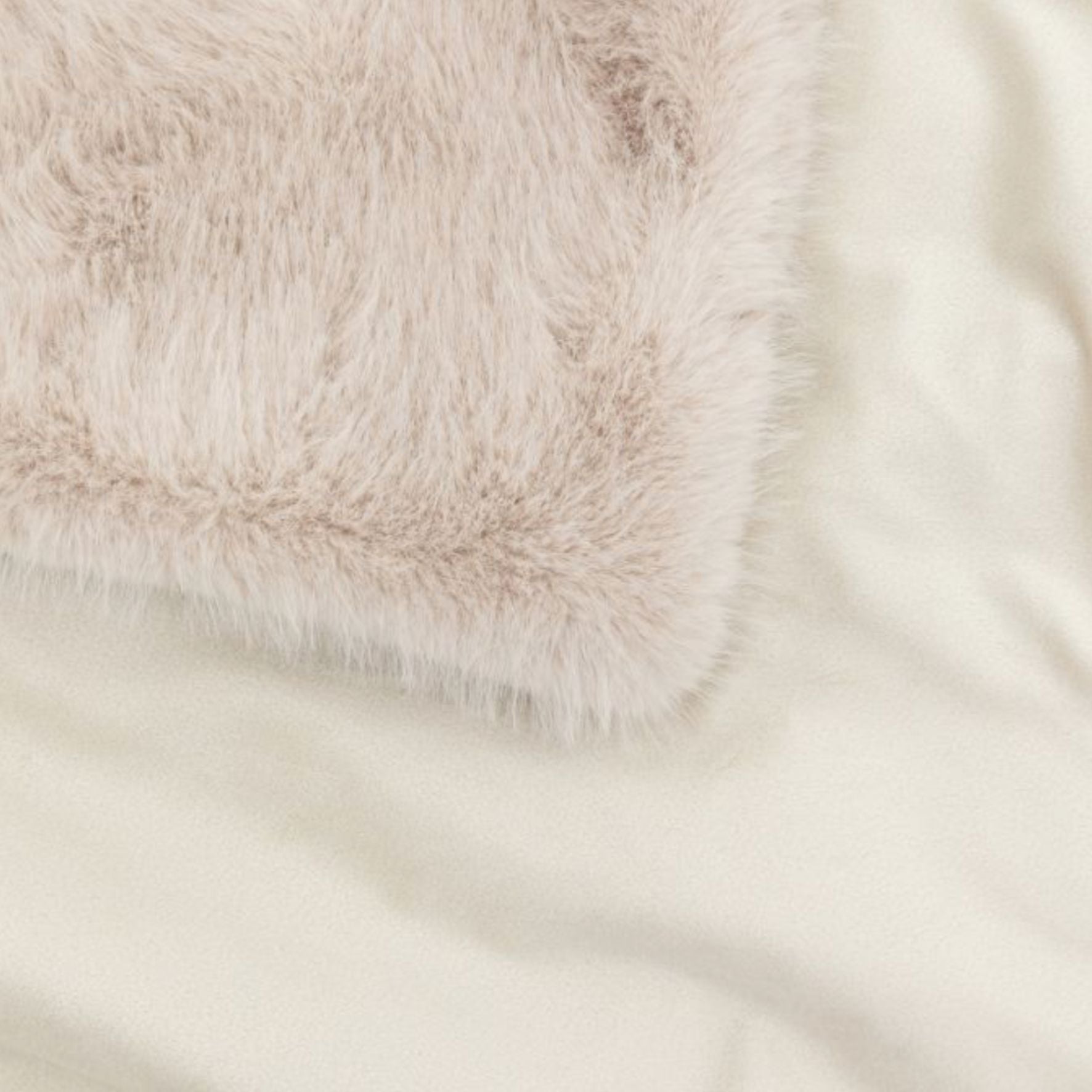 Close-up of oatmeal beige fur fabric with a soft texture