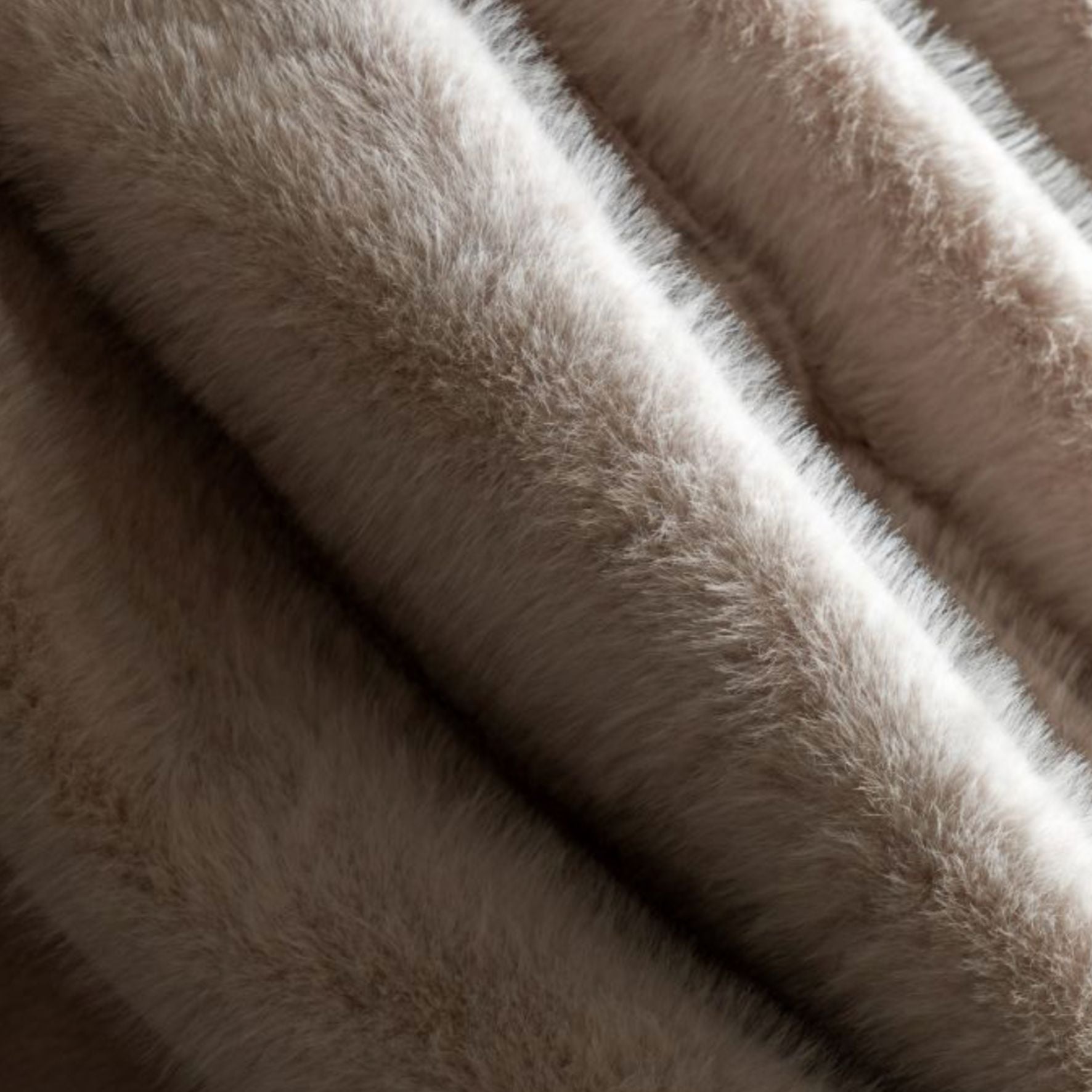 Close-up of oatmeal fur fabric with a soft texture
