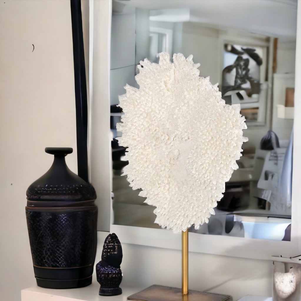 White Faux Coral on a Stand on a mantelpiece