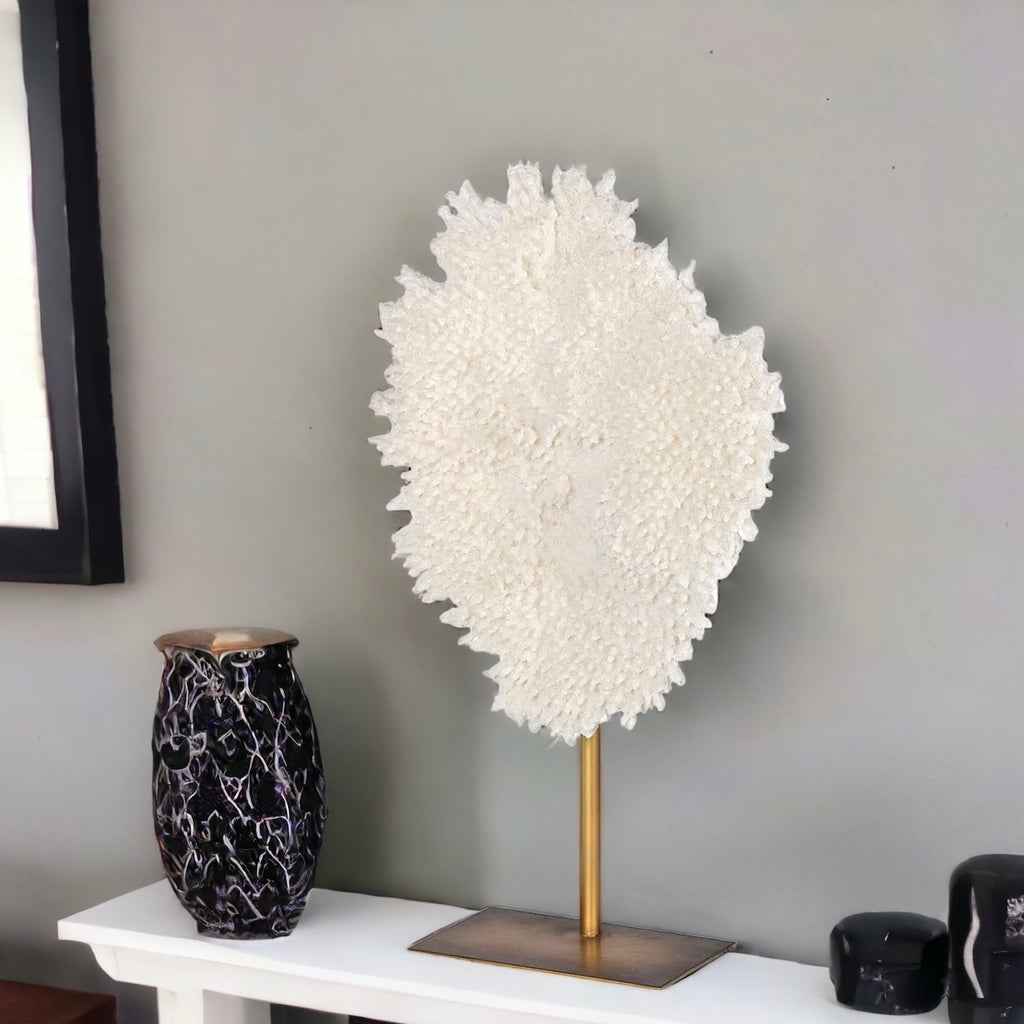 White Faux Coral on a Stand on a mantlepiece