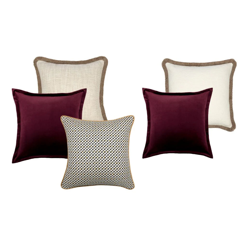 Set of four pillows with different patterns on a white background