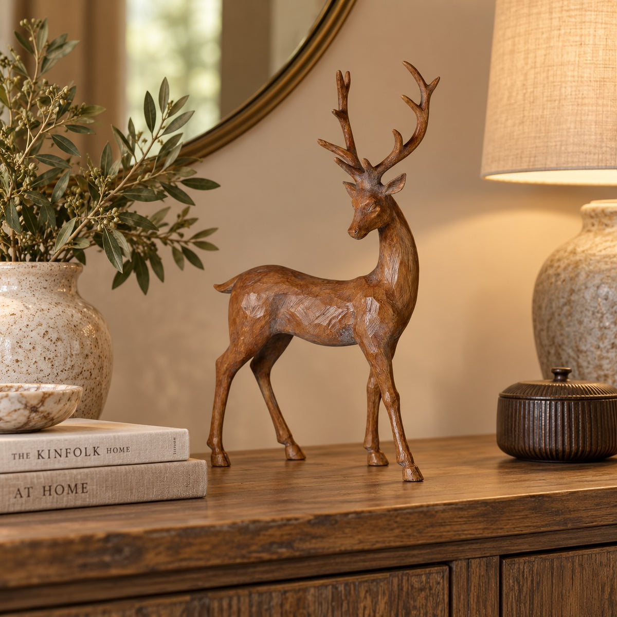 Rustic standing stag styled on a neutral console with greenery and candlelight