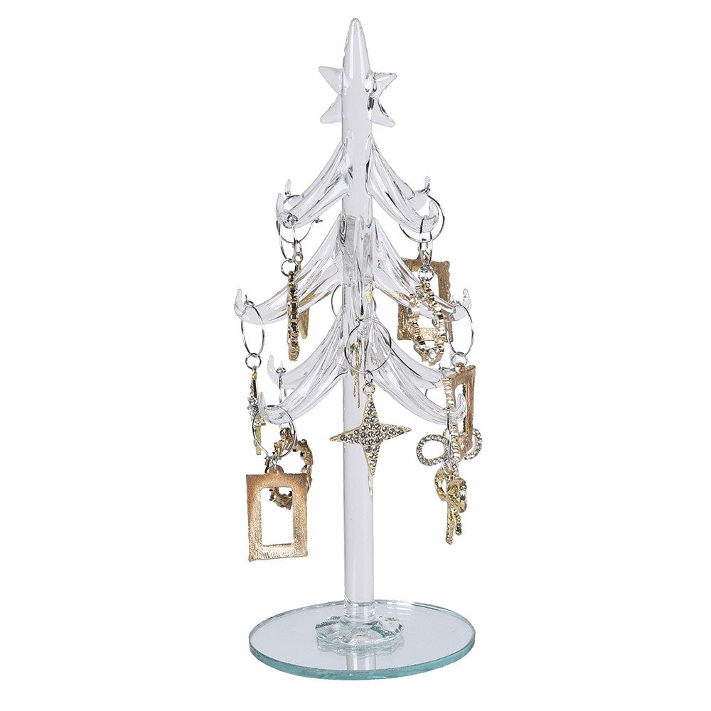 A clear glass Christmas tree jewellery display stand with a star topper and multiple branches, shown holding several gold and silver earrings on a plain white background.