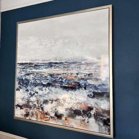 Abstract coastal canvas art with gold frame showcasing an artistic representation of a misty seaside view with brushstrokes in blue, grey, and earth tones, Elm & Grey.