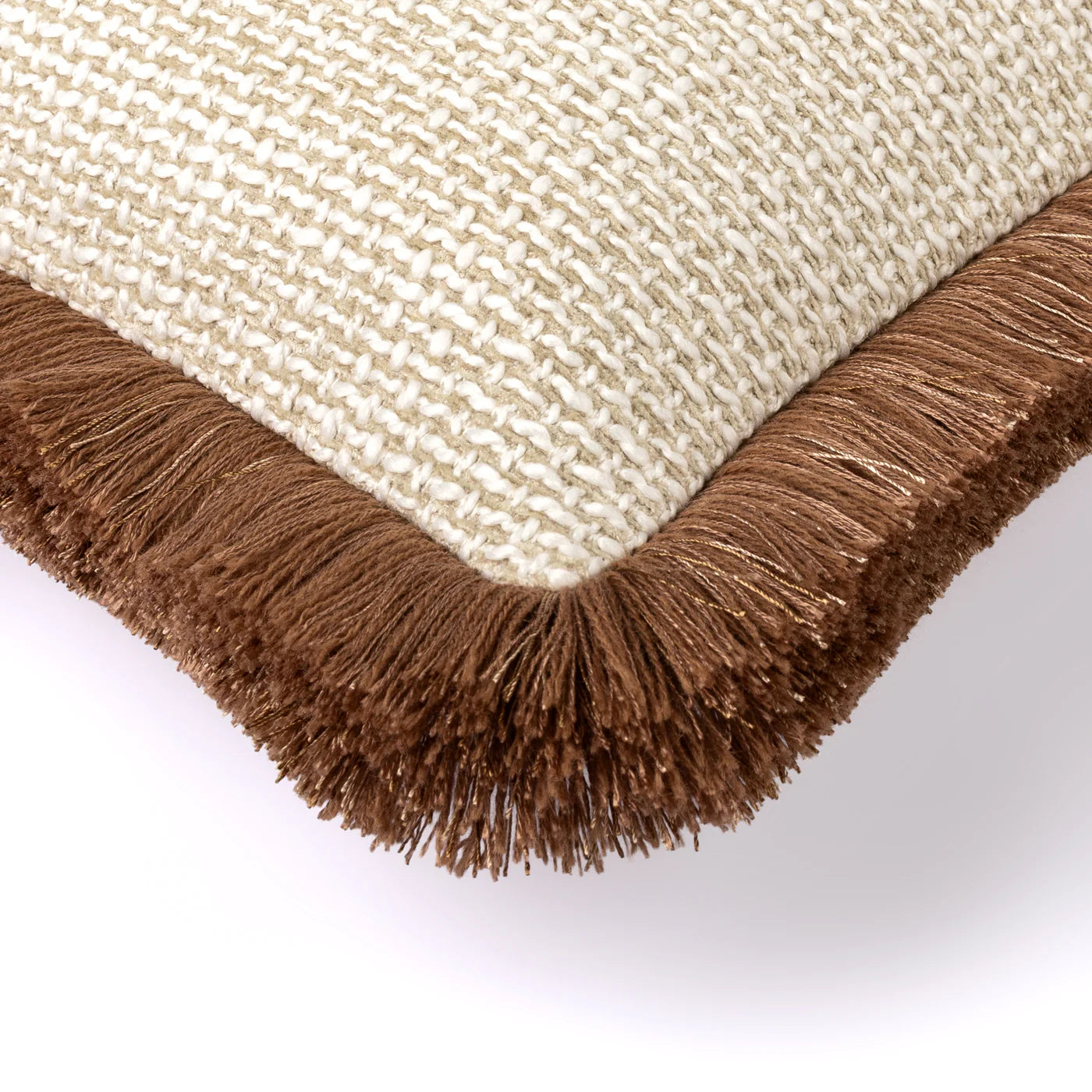 Close-up of a beige cushion with brown fringes on a white background