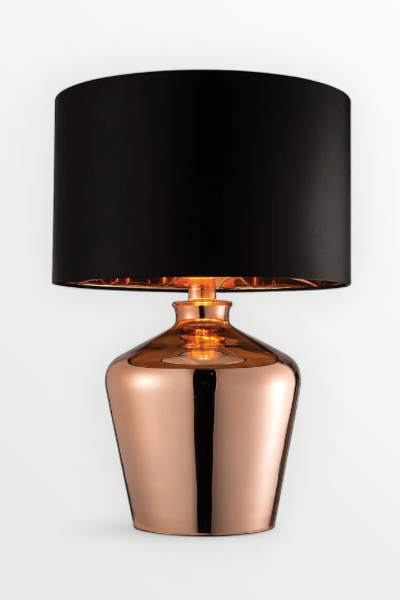 a lamp with a copper base and black shade on a white background