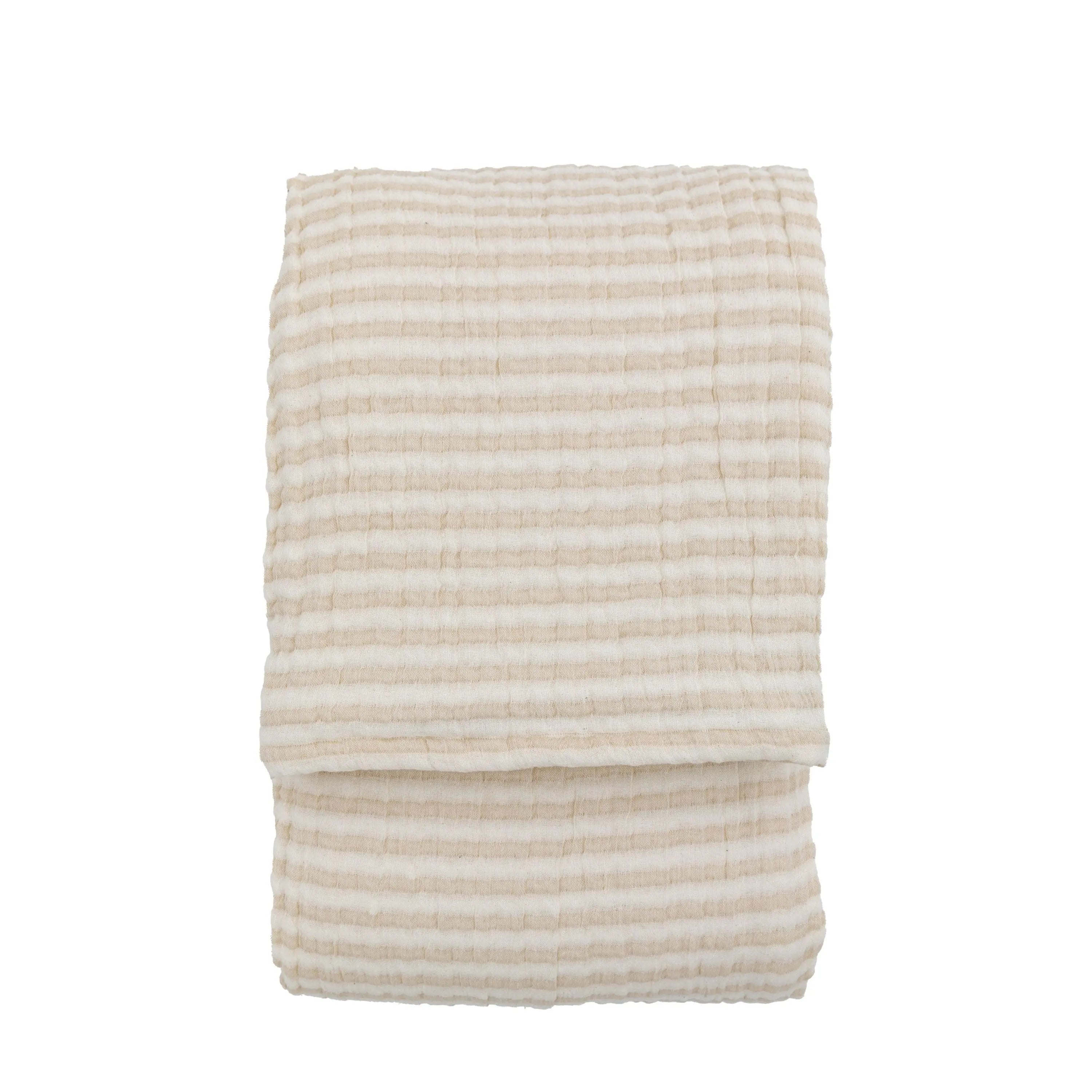 Folded beige and white striped bedspread on a white background