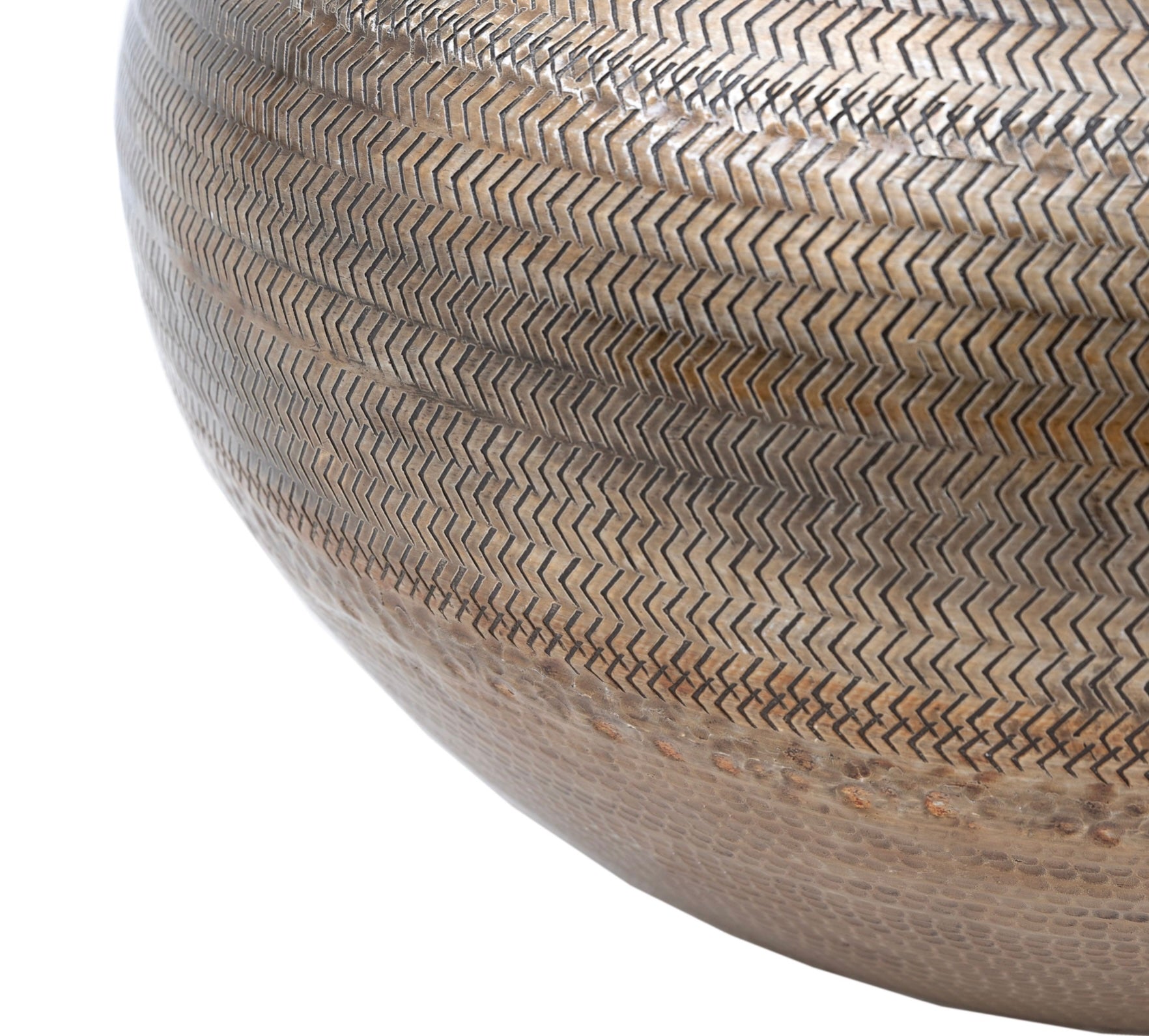Close-up of a textured antiqued brass vase on a white background