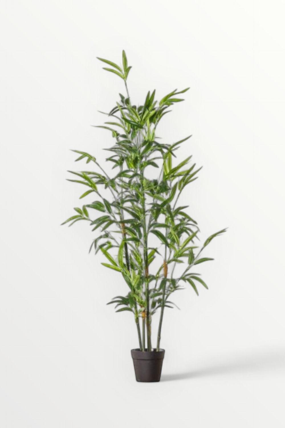 Artificial bamboo plant in a pot on a white background