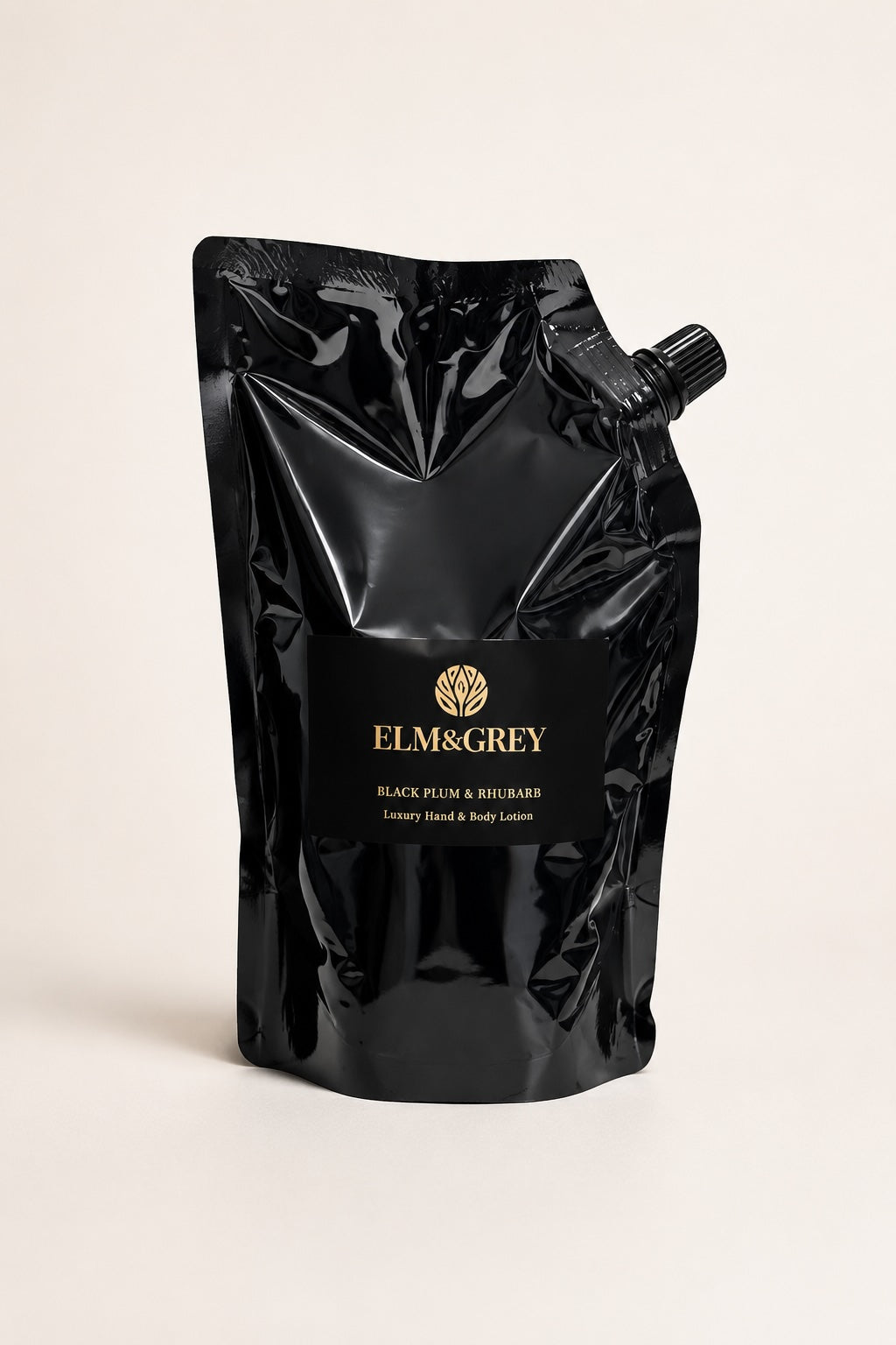 Elm & Grey Black Plum & Rhubarb hand and body lotion refill pouch on a neutral studio background