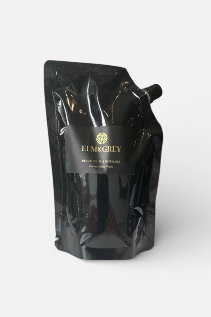 Black refill pouch for black plum and rhubarb wash with 'Elm & Grey' branding on a white background