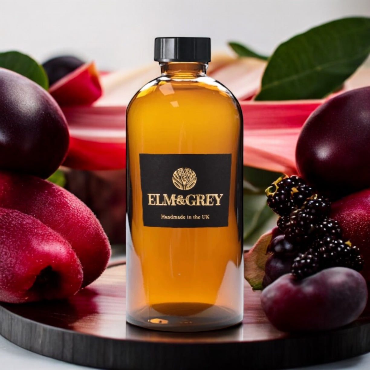Bottle of Elm & Grey product surrounded by fruits on a wooden board
