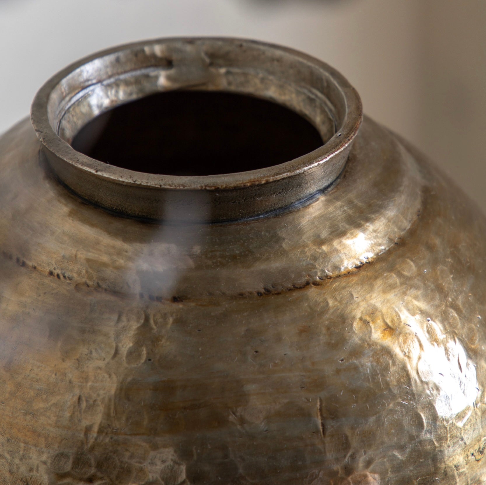 Close-up of a textured metallic container with a dark interior.