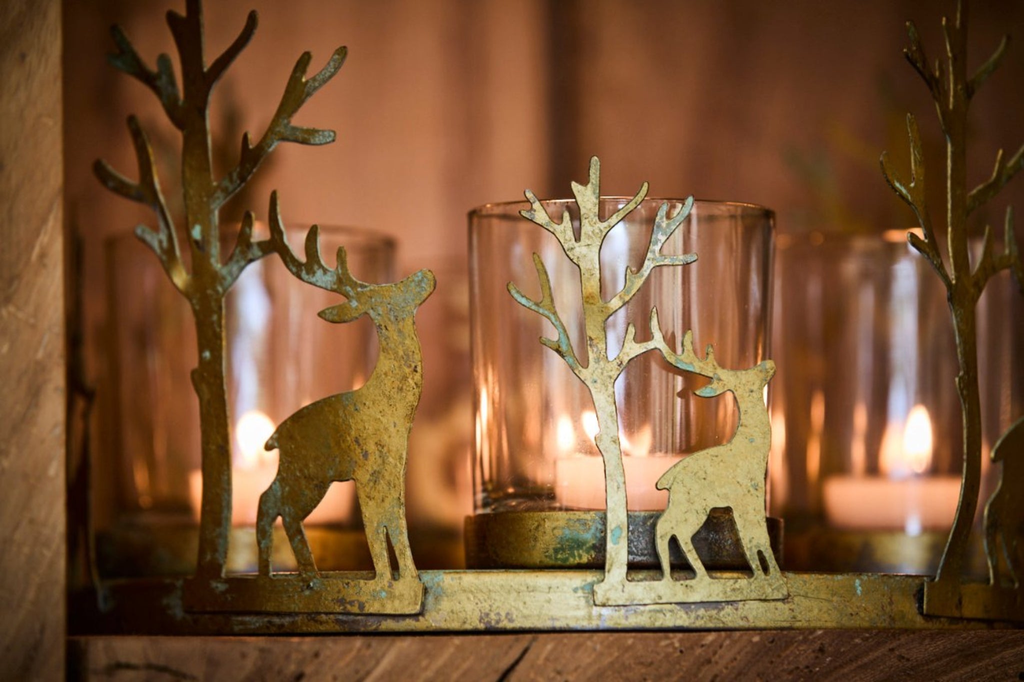 Decorative metal reindeer candle holders with candles in a warm setting
