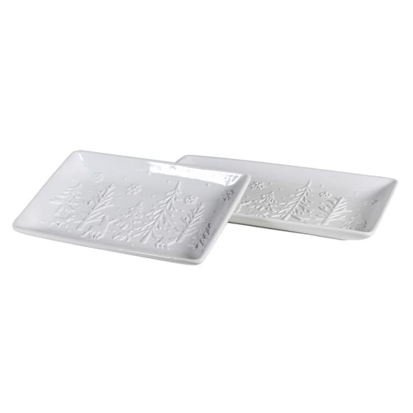 Two white ceramic trays with floral patterns on a white background