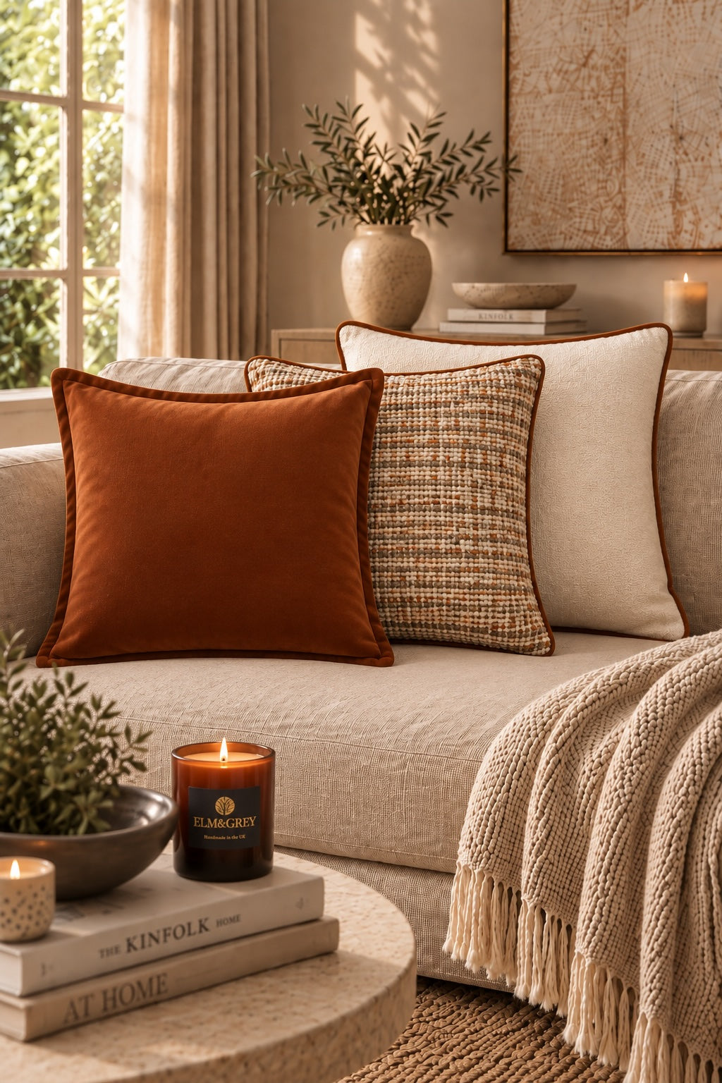 Bouclé Carnelian and Citrine curated luxury cushion trio in warm cream and rust tones on a neutral sofa
