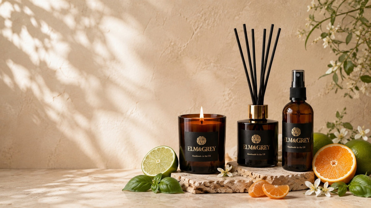 Elm & Grey citrus home fragrance collection with lit candle, reed diffuser and room spray styled with fresh lime, orange blossom and citrus fruits