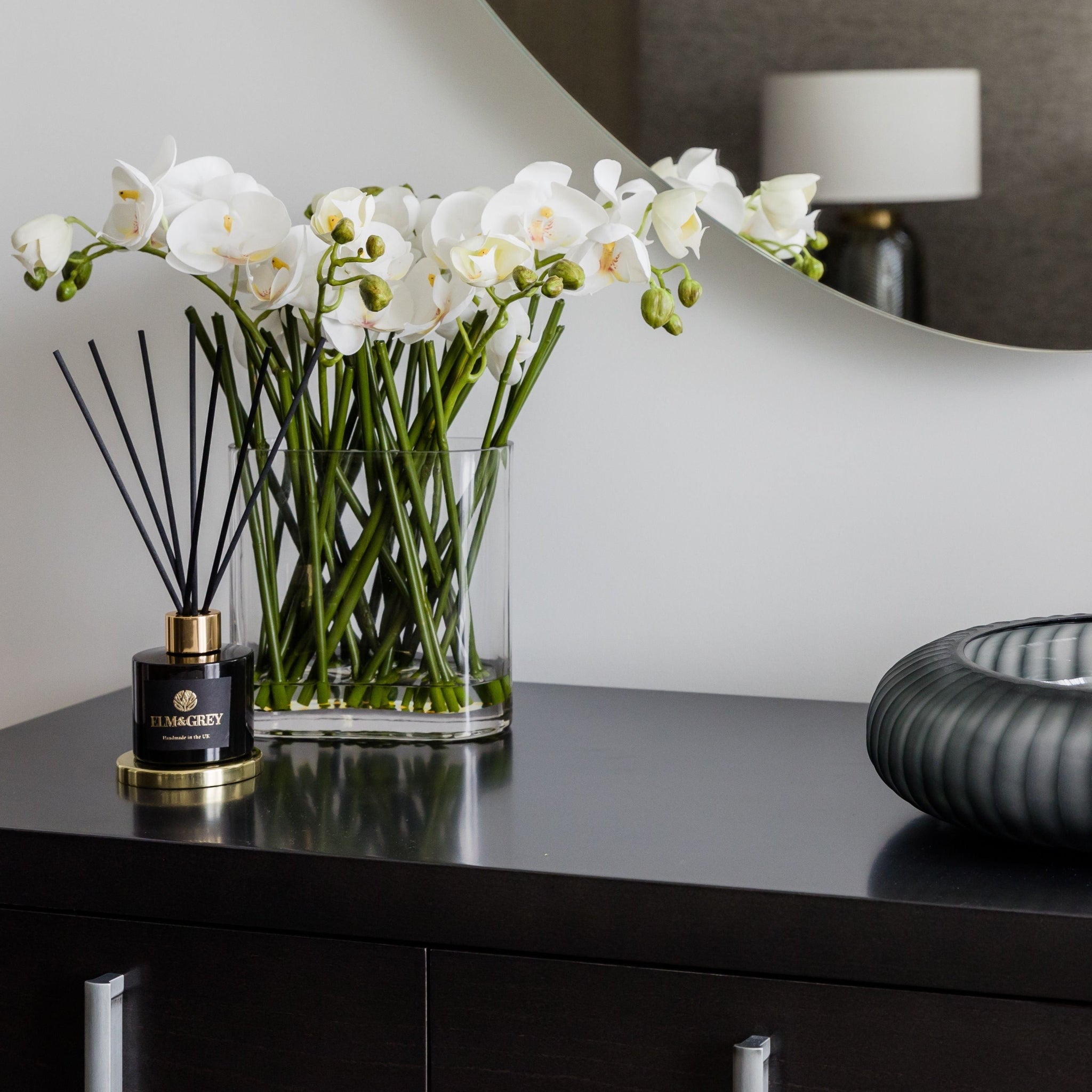 diffuser on sideboard with orchid display