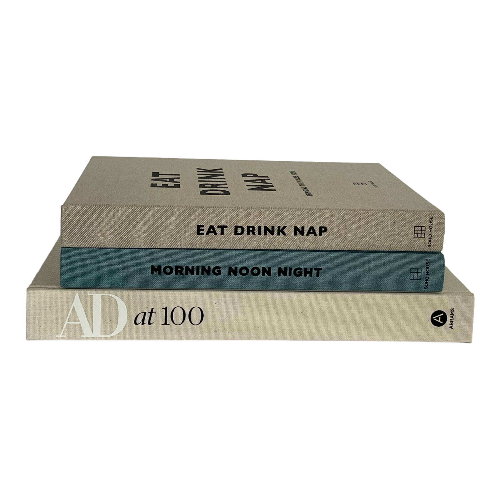 Stack of coffee table books including Soho House, Morning Noon and Night and Eat, Drink, Nap. Elm & Grey.