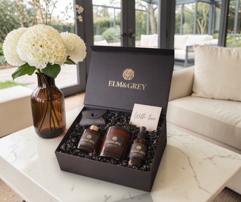 Gift set from Elm&Grey on a marble table with flowers and a couch in the background