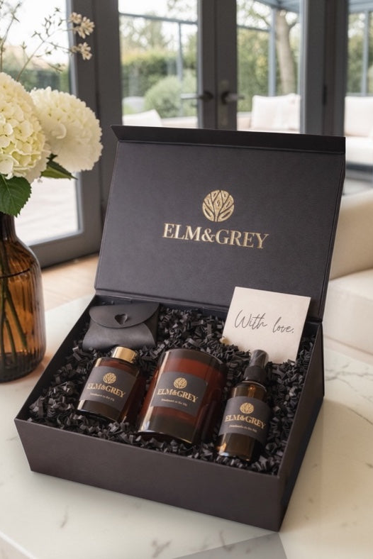 Gift set from Elm&Grey with three bottles and a card on a decorative surface.