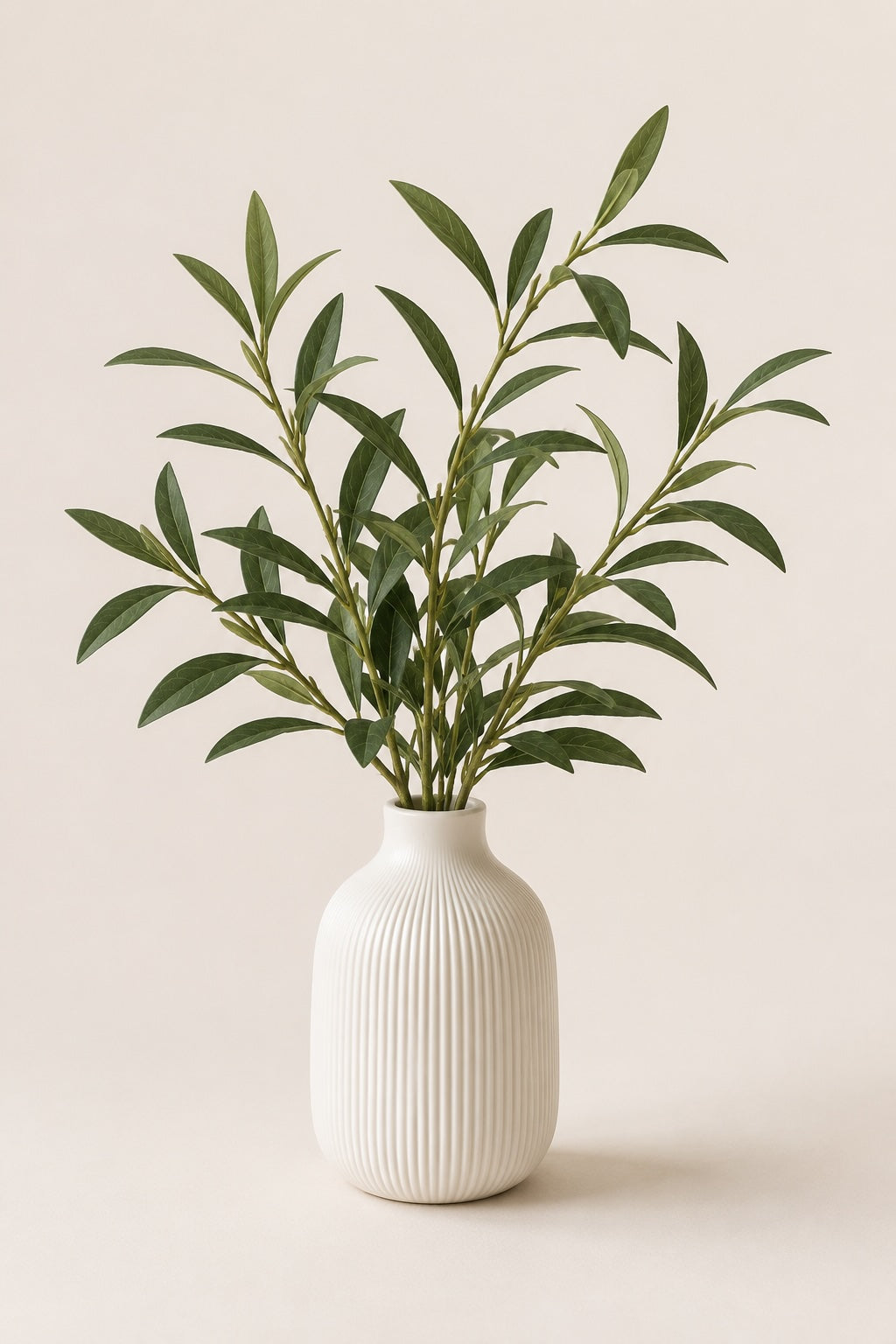 White textured vase with faux olive arrangement by Elm and Grey  on a beige background