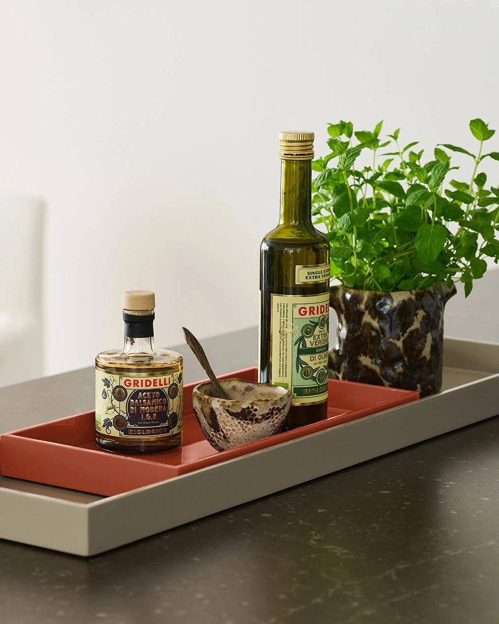 Fawn high gloss lacquer rectangular tray on a kitchen surface styled with Gridelli olive oil, balsamic vinegar, fresh herbs in a ceramic planter and small stoneware bowl — Elm & Grey