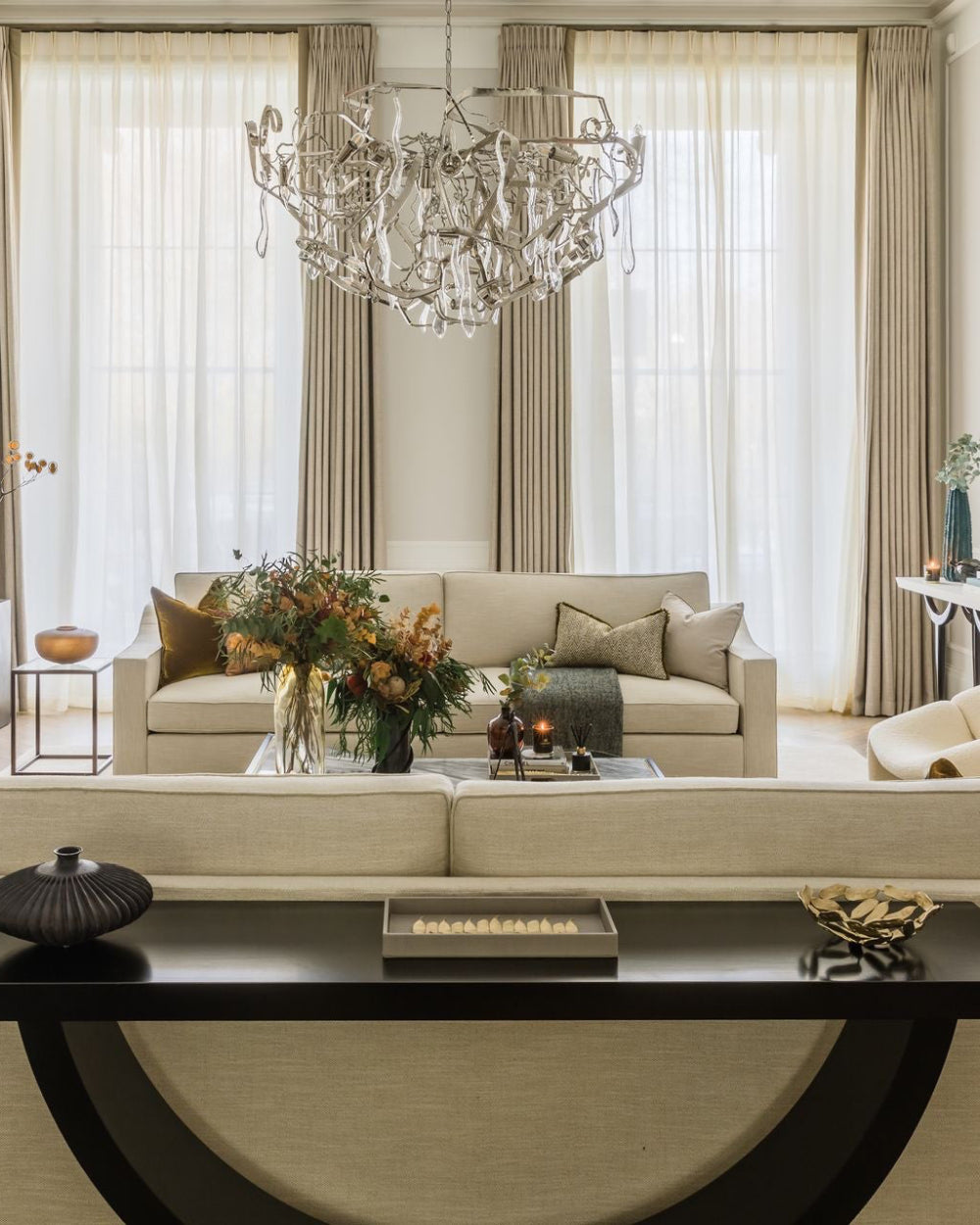 Fawn high gloss lacquer rectangular tray on a console table in a luxury living room with crystal chandelier, floor-to-ceiling drapes and dramatic autumn floral arrangement — Elm & Grey