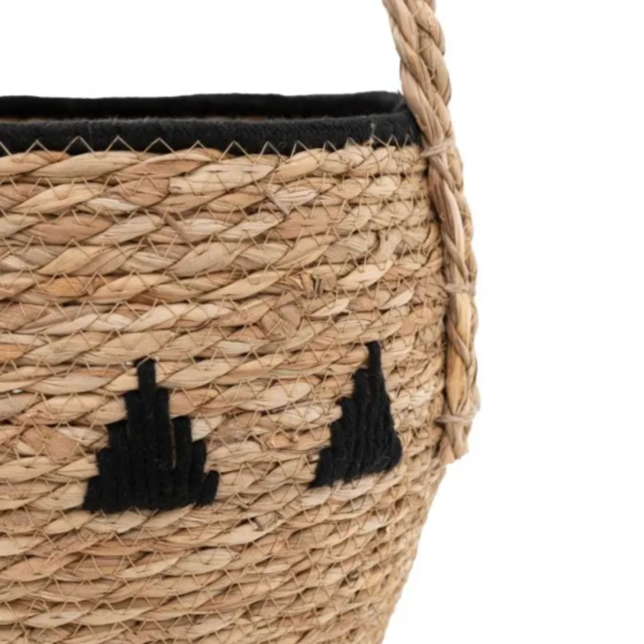 Woven basket with black decorative elements on a white background