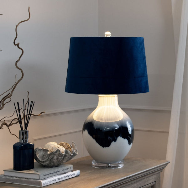 Glazed Blue and White Shaddow Lamp on a side board with Blue Velvet Shade