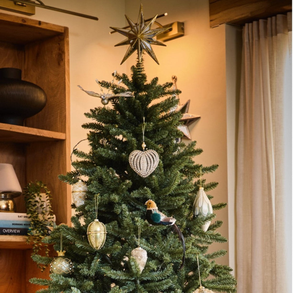 Decorated Christmas tree with ornaments in a room setting