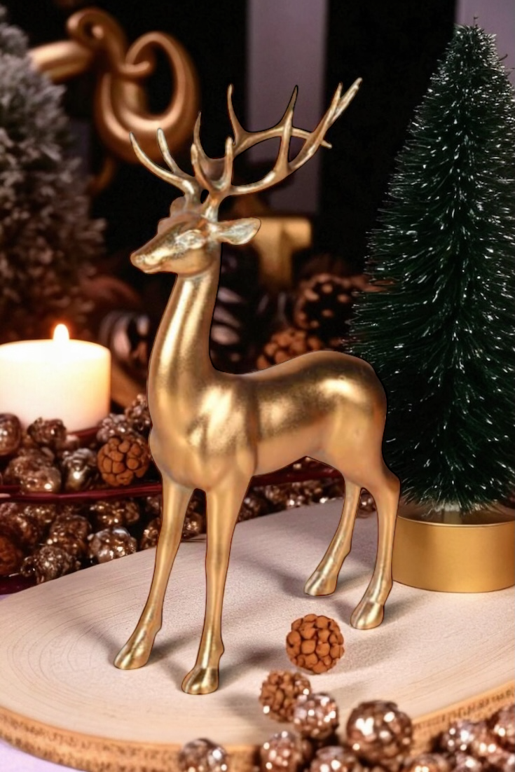 Gold deer figurine on a decorative surface with pinecones and a candle.