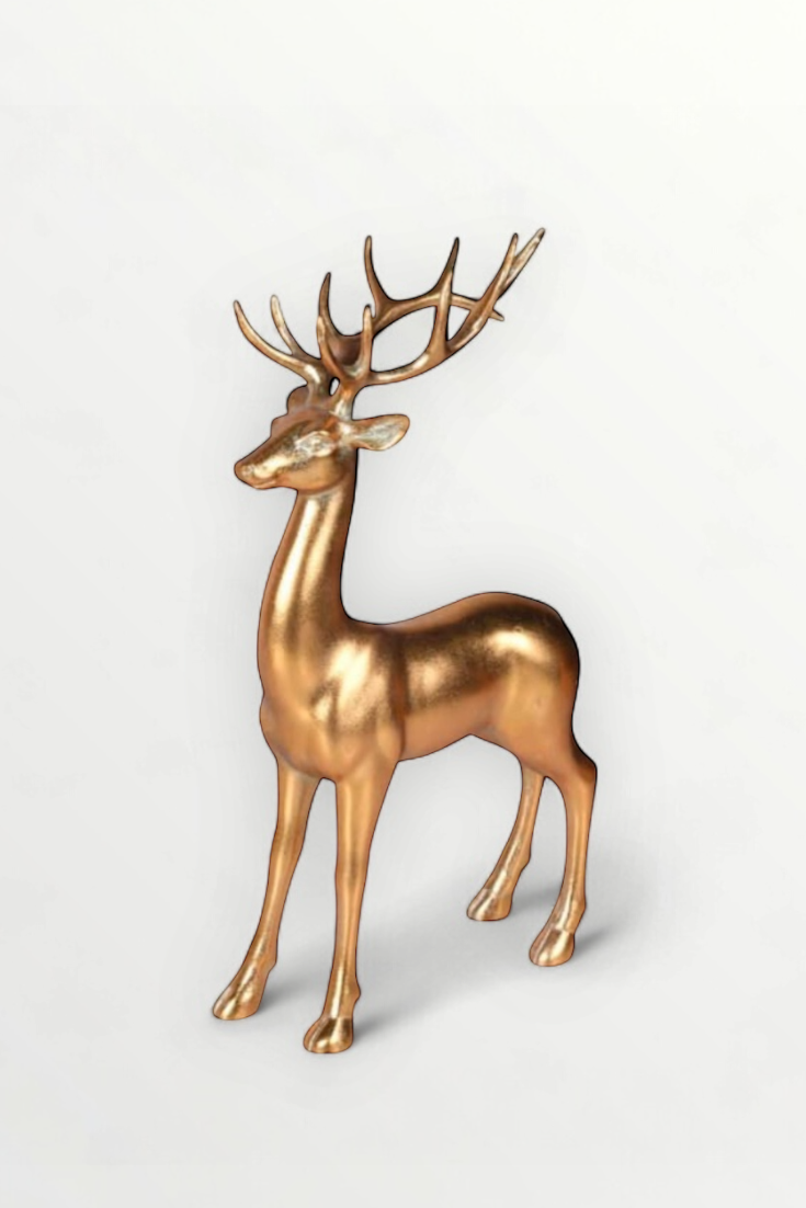 Gold deer figurine on a light gray background