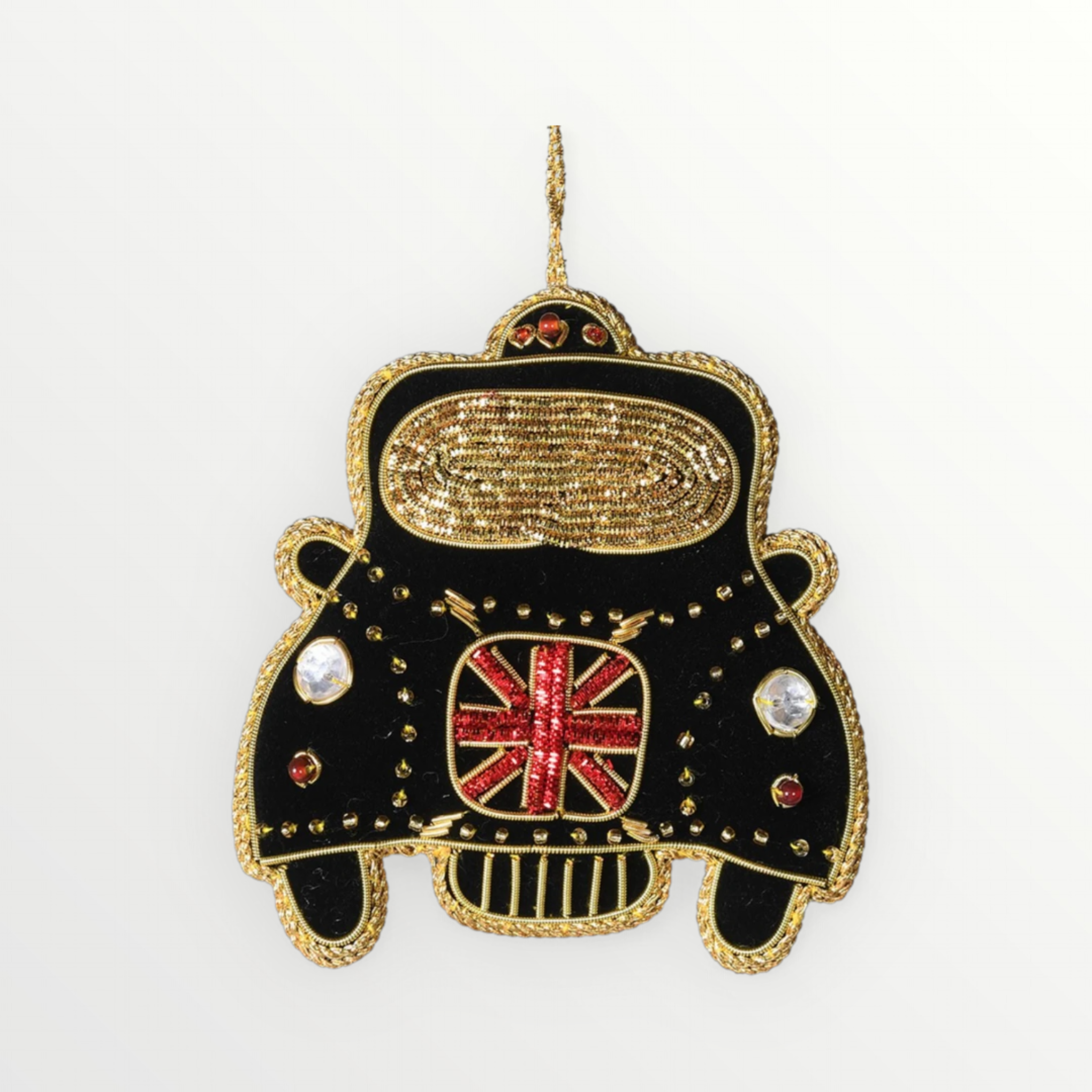 A black and gold London taxi cab hanging decoration adorned with gold embroidery, jewels, and a Union Jack motif.