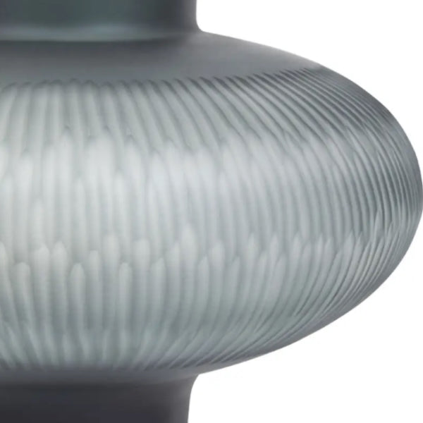 Close-up of a textured cut glass vase on a white background