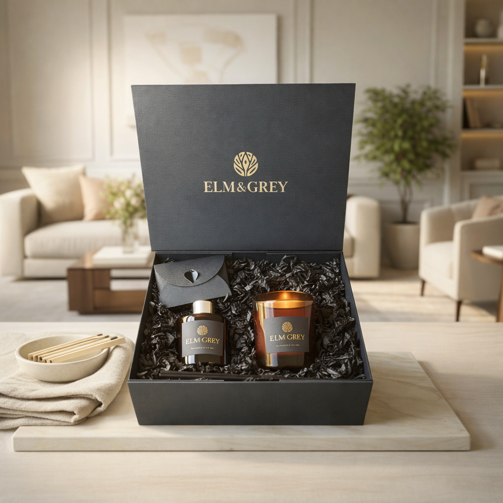 Gift set from Elm&Grey with a candle and bottle in a decorative box on a table.