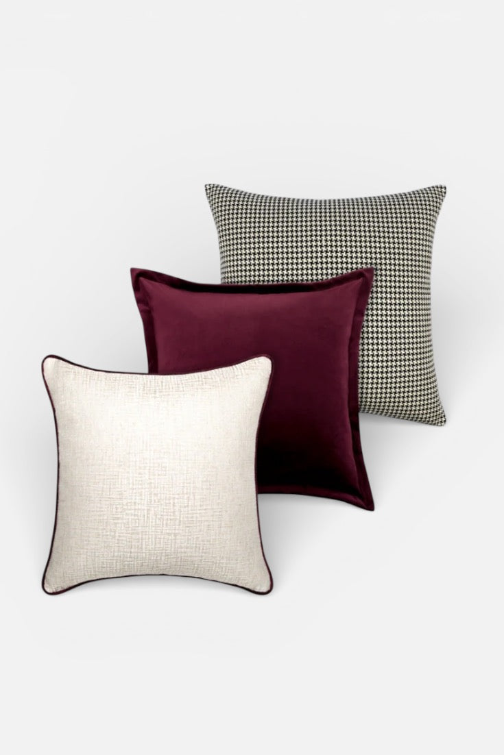 Four cushions with different patterns on a white background
