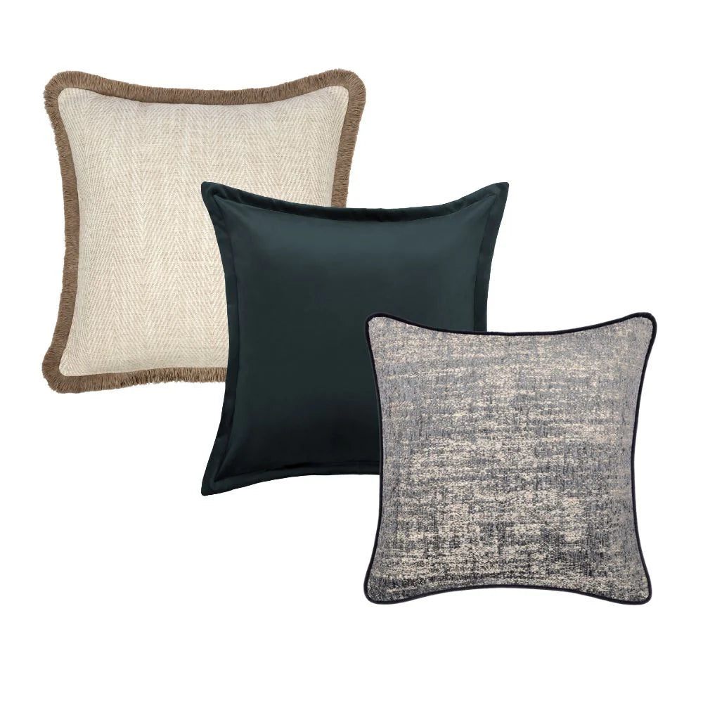 Three decorative pillows with different textures and colors on a white background