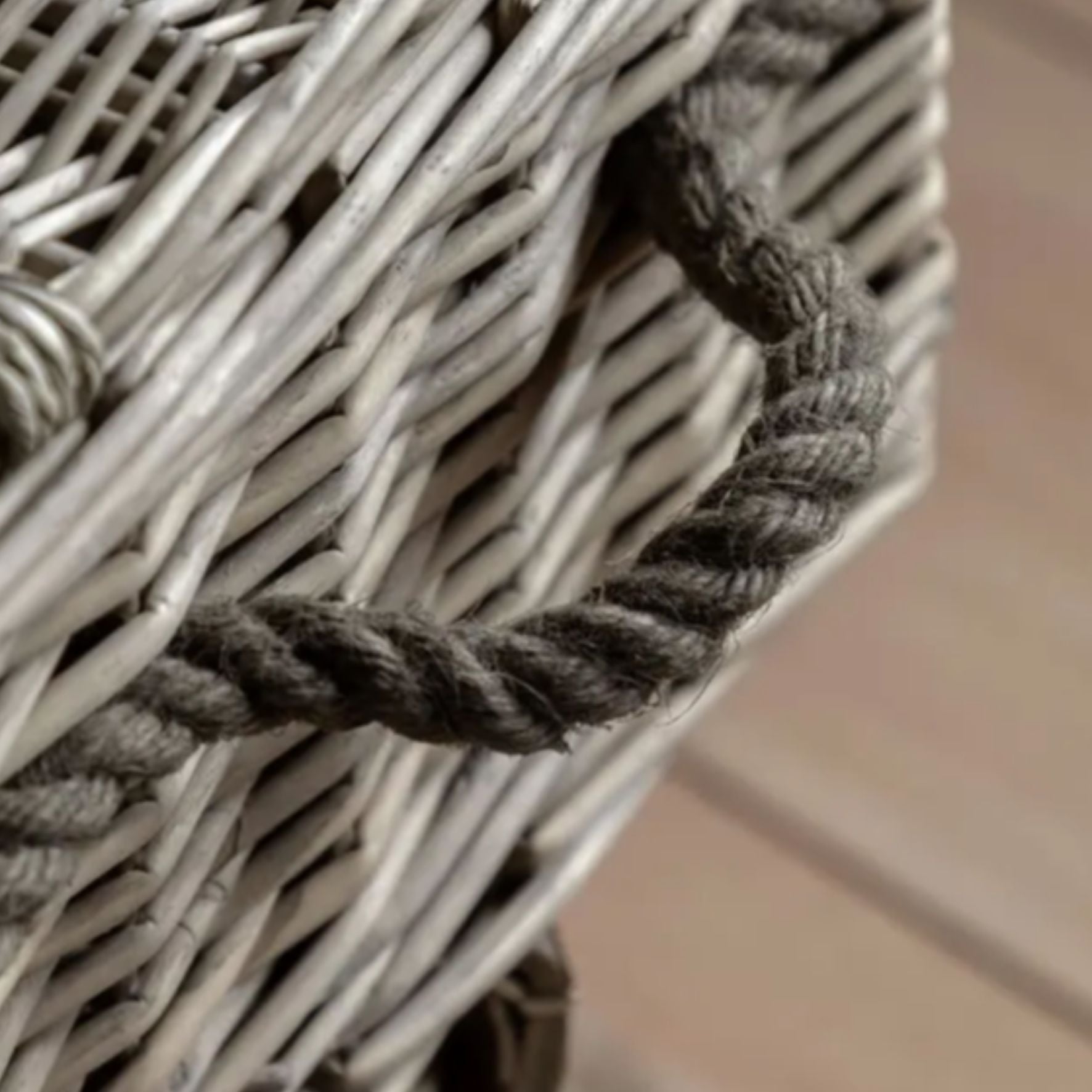 Close-up of a woven basket with a rope handle on a blurred background