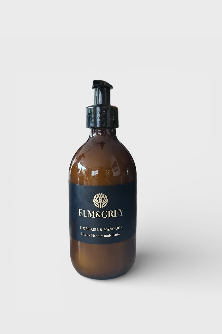 Amber bottle with black cap labeled 'Elm & Grey' on a white background