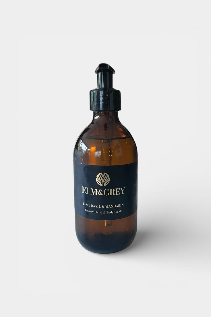 Amber glass bottle with black cap labeled 'Elm & Grey' on a white background