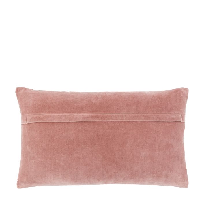Pink velvet pillow on a white background