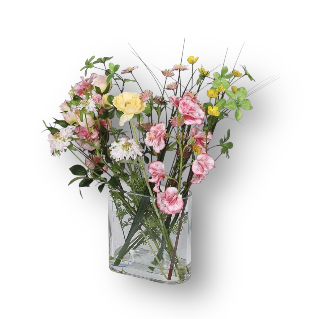 Clear glass vase with a bouquet of pink, yellow, and white flowers on a white background
