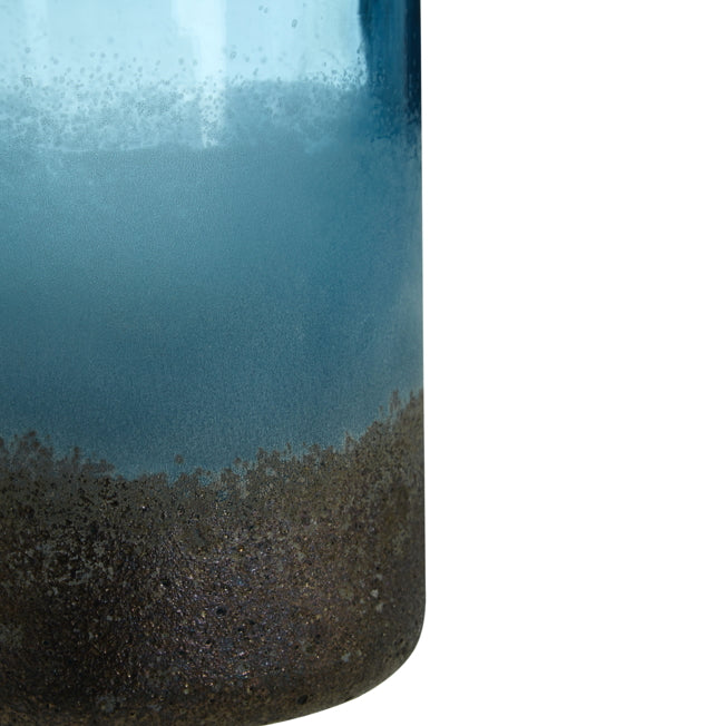 Close-up of a blue glass vase with a textured base